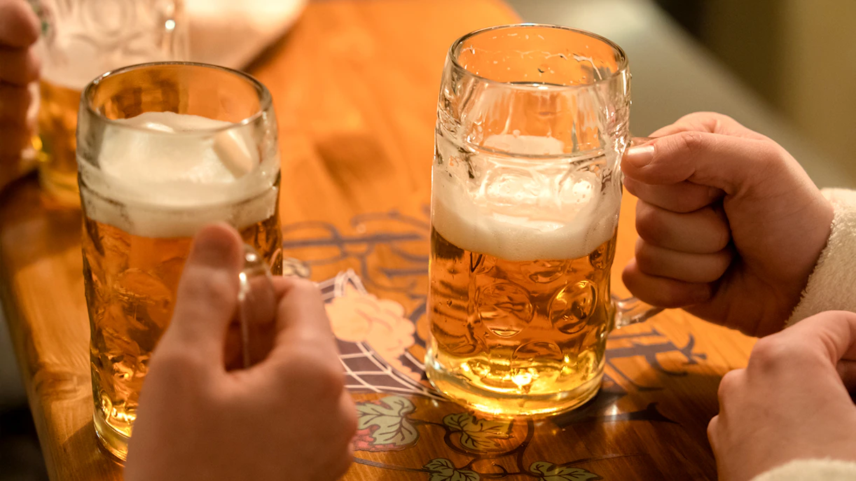 Two people cheerfully enjoying beer in Bruges, Belgium.