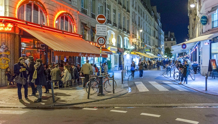 Tourists exploring the vibrant streets of Paris' Latin Quarter on a self-guided audio tour
