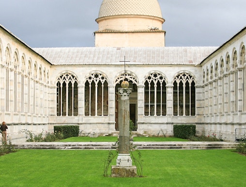 Camposanto Monumentale courtyard with central cross and dome in Pisa, Italy.