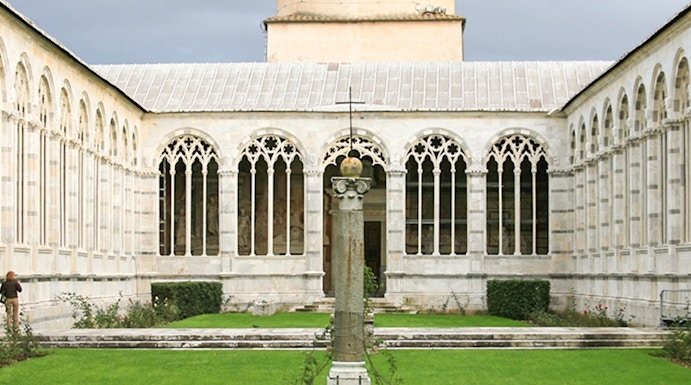 Camposanto Monumentale courtyard with central cross and dome in Pisa, Italy.