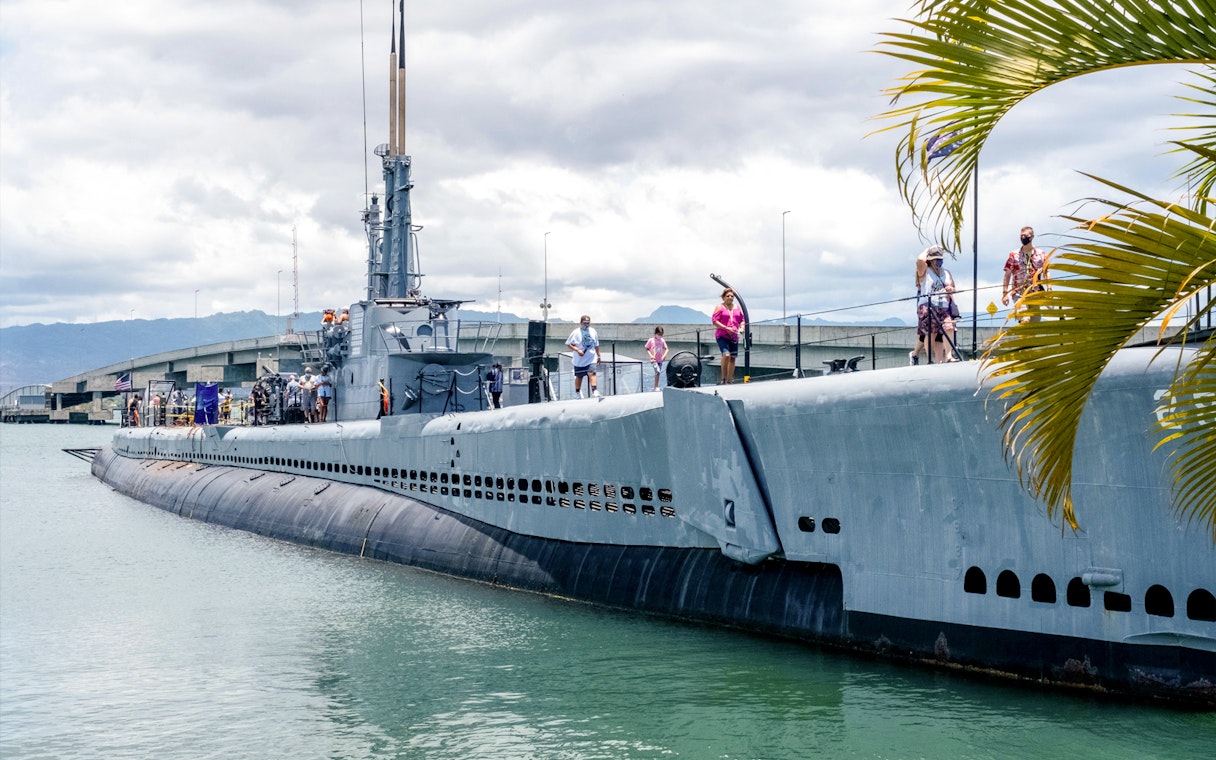 Visitors exploring a Pacific Fleet submarine docked at Pearl Harbor.