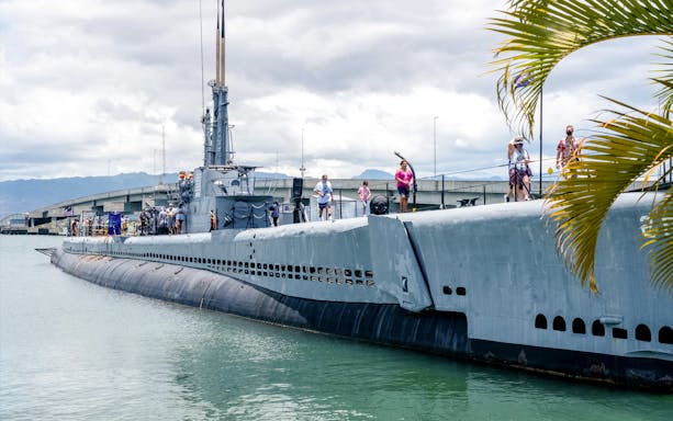 Visitors exploring a Pacific Fleet submarine docked at Pearl Harbor.