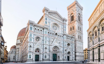 Florence Cathedral with marble façade and bell tower in morning light, Italy.