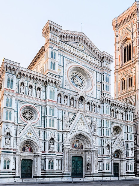 Florence Cathedral with marble façade and bell tower in morning light, Italy.