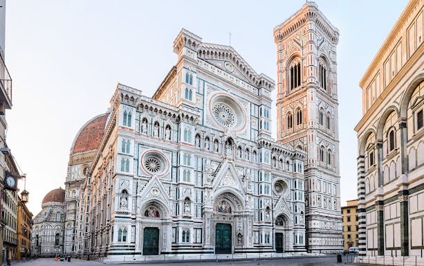 Florence Cathedral with marble façade and bell tower in morning light, Italy.