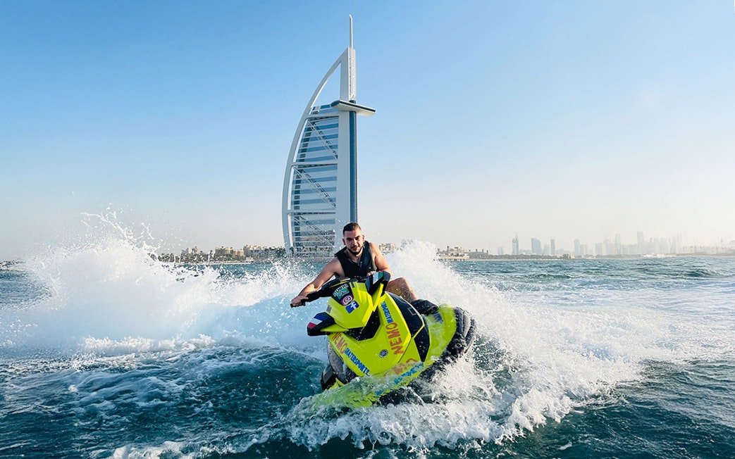 Tourist on jet ski near Burj Al Arab in Dubai.