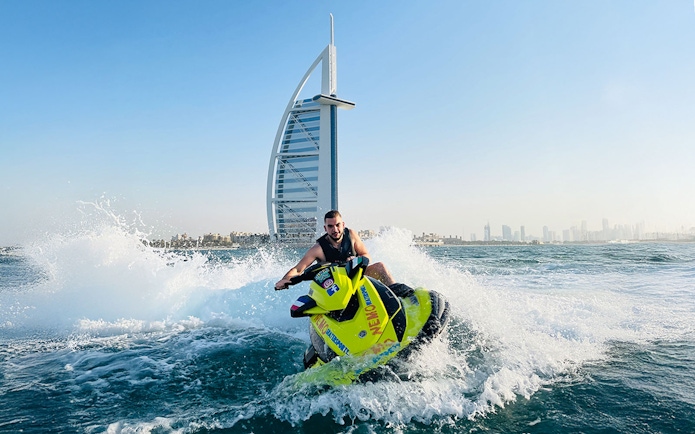 Tourist on jet ski near Burj Al Arab in Dubai.