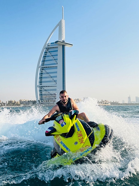 Tourist on jet ski near Burj Al Arab in Dubai.