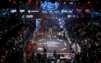 Muay Thai fight at World Siam Stadium in Bangkok with a packed audience.