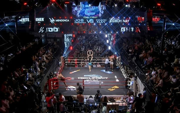 Muay Thai fight at World Siam Stadium in Bangkok with a packed audience.