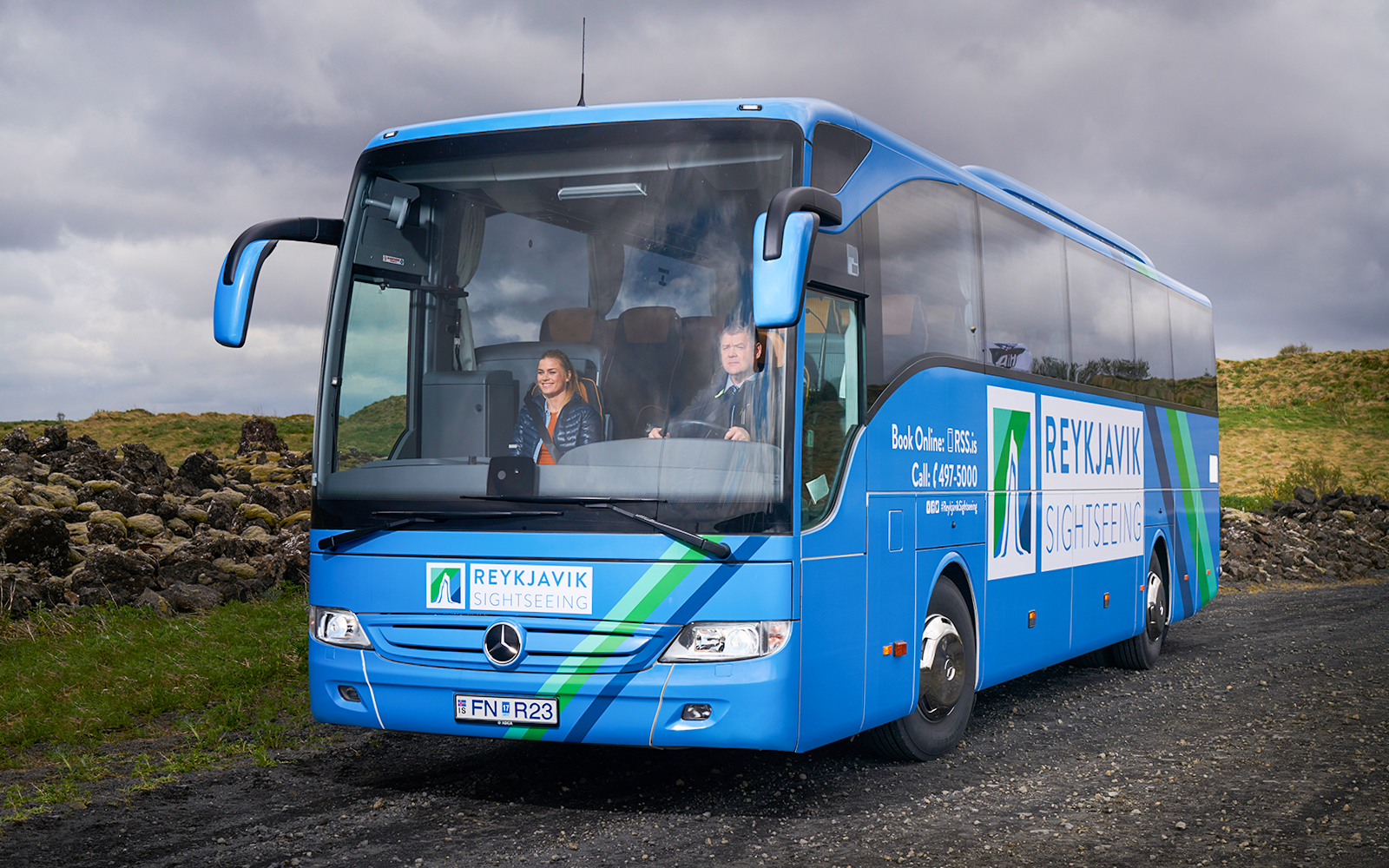 Reykjavik sightseeing bus on Golden Circle tour route with passengers.