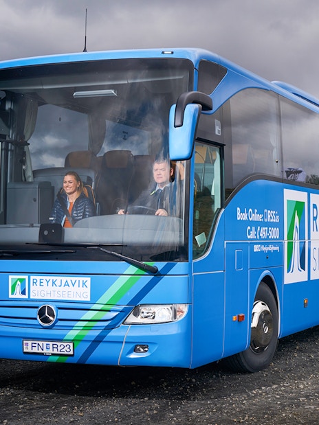 Reykjavik sightseeing bus on Golden Circle tour route with passengers.
