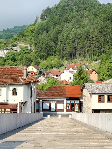 Stone bridge leading to traditional buildings and mosque in Konjic town, Bosnia and Herzegovina.