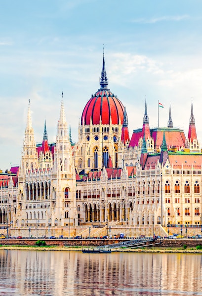 Hungarian Parliament building with reflection on the Danube River in Budapest.