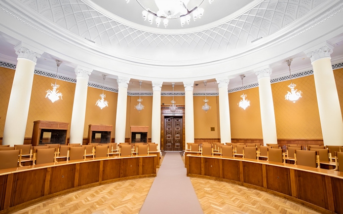 Interior of a conference room with columns and ornate ceiling at the Palace of Culture and Science.