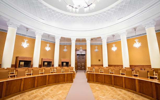 Interior of a conference room with columns and ornate ceiling at the Palace of Culture and Science.