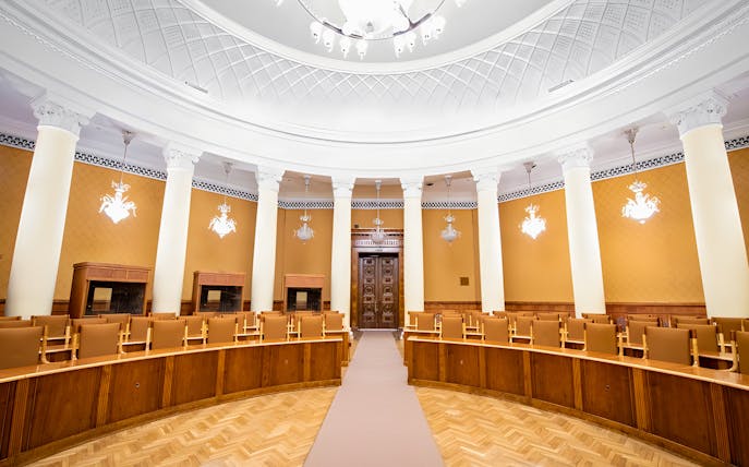 Interior of a conference room with columns and ornate ceiling at the Palace of Culture and Science.