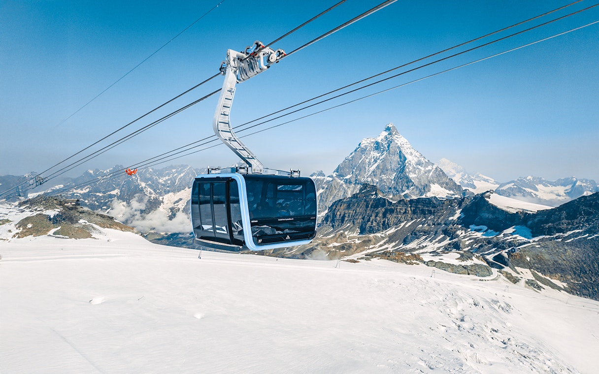 Cable car ascending Matterhorn Glacier Paradise with snowy mountain backdrop.