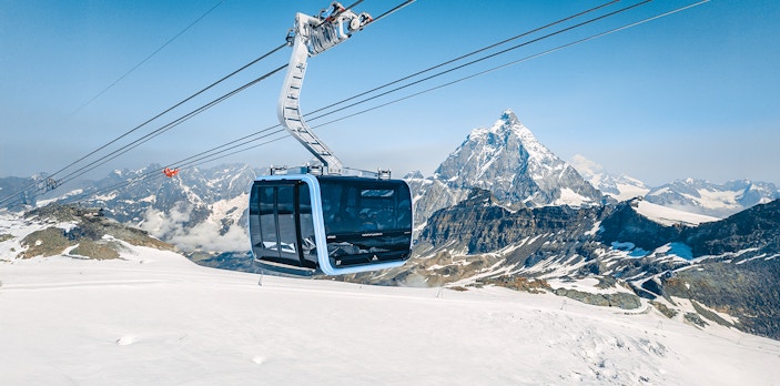 Cable car ascending Matterhorn Glacier Paradise with snowy mountain backdrop.