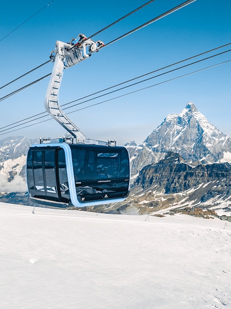 Cable car ascending Matterhorn Glacier Paradise with snowy mountain backdrop.