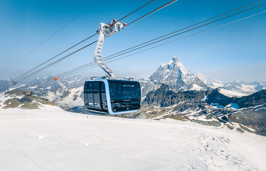 Cable car ascending Matterhorn Glacier Paradise with snowy mountain backdrop.