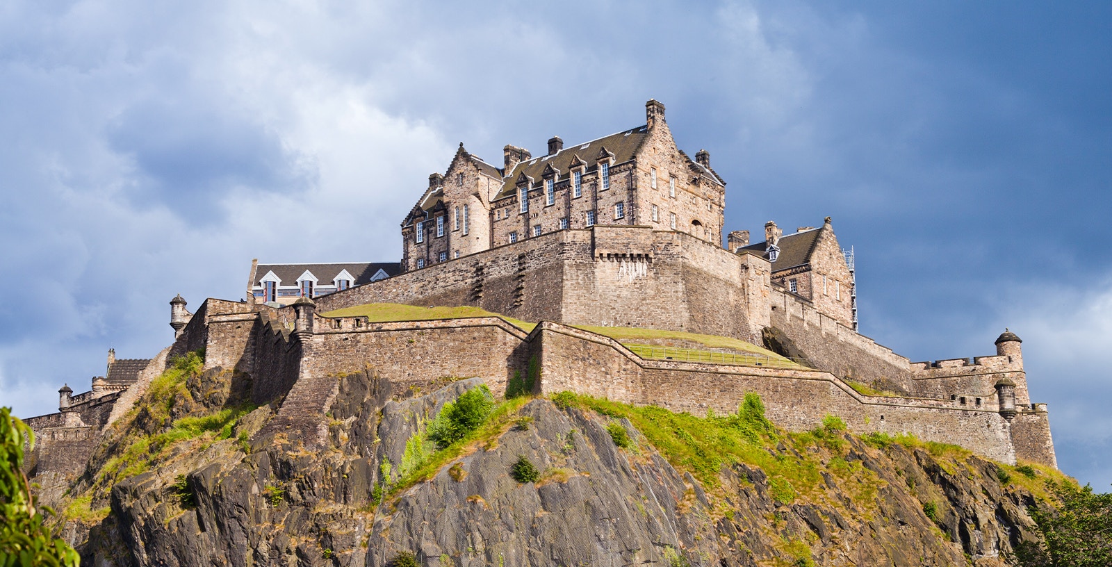 Edinburgh Castle on Castle Rock under a cloudy sky.