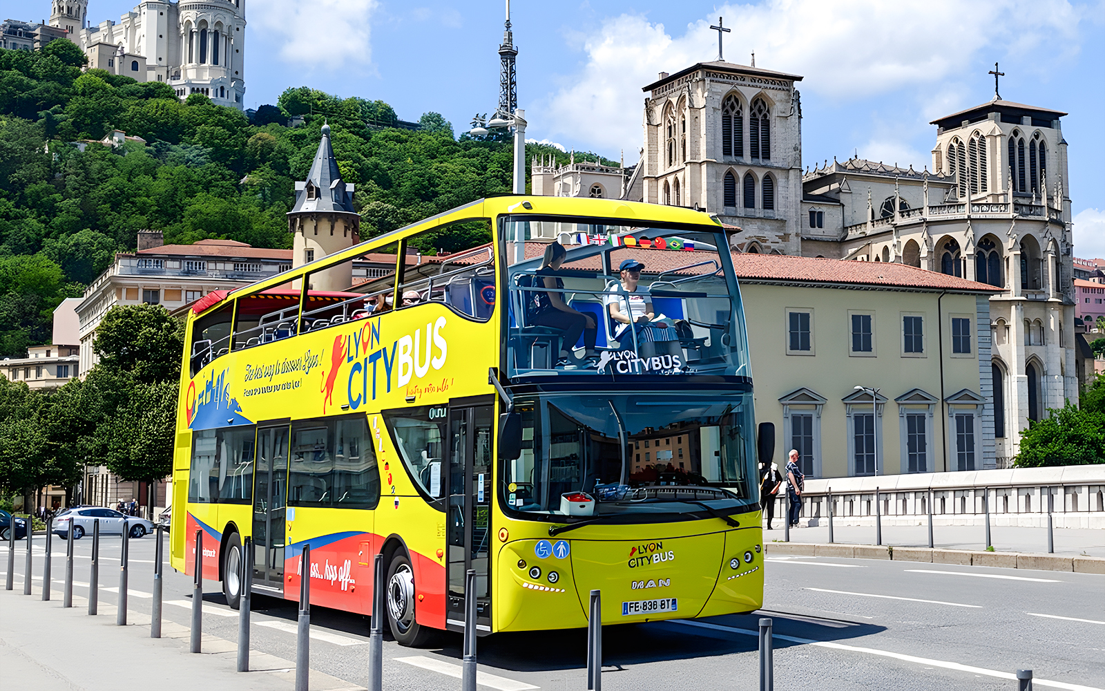 Lyon city tour bus in front of Basilica of Notre-Dame de Fourvière, France.