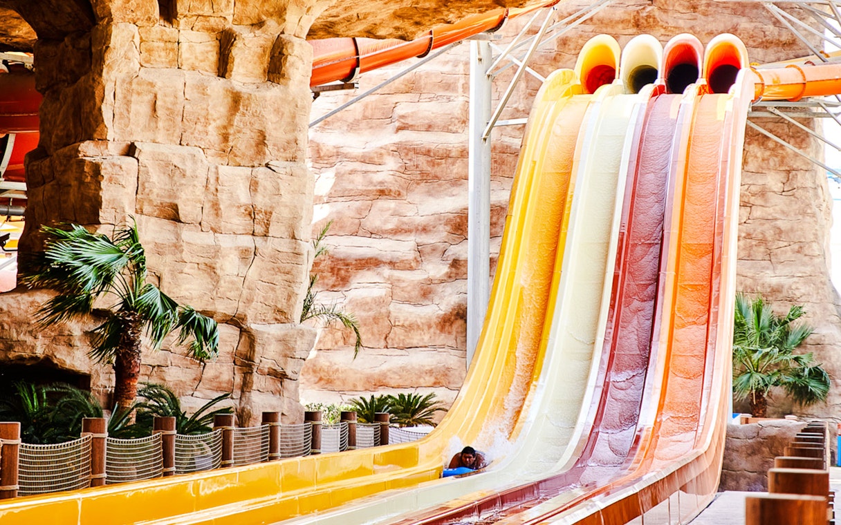 Water slide with colorful lanes in Doha theme park.