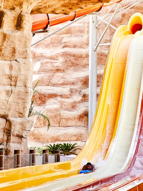 Water slide with colorful lanes in Doha theme park.