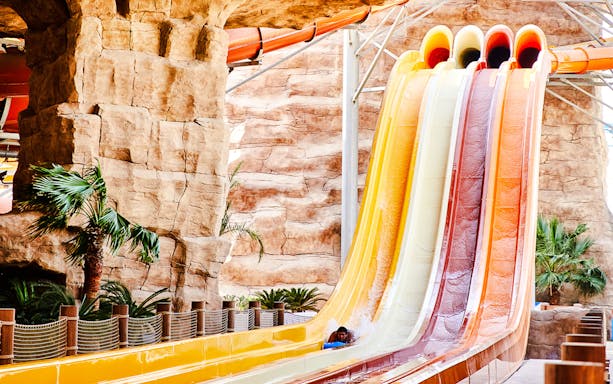 Water slide with colorful lanes in Doha theme park.