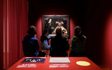 Visitors viewing a Rembrandt painting at the Rembrandt House Museum.