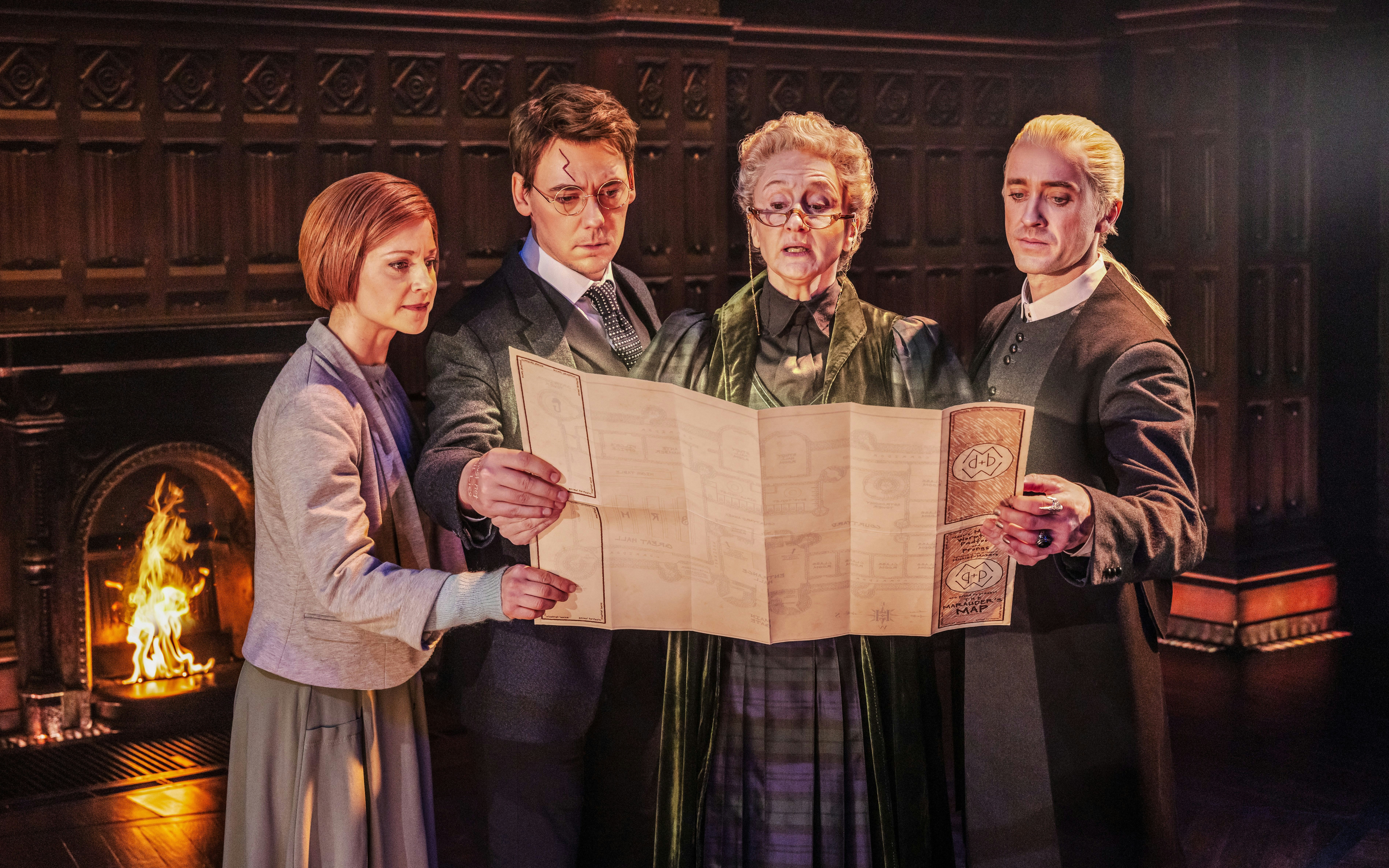 Actors examining a map during a scene from Harry Potter and the Cursed Child on Broadway.