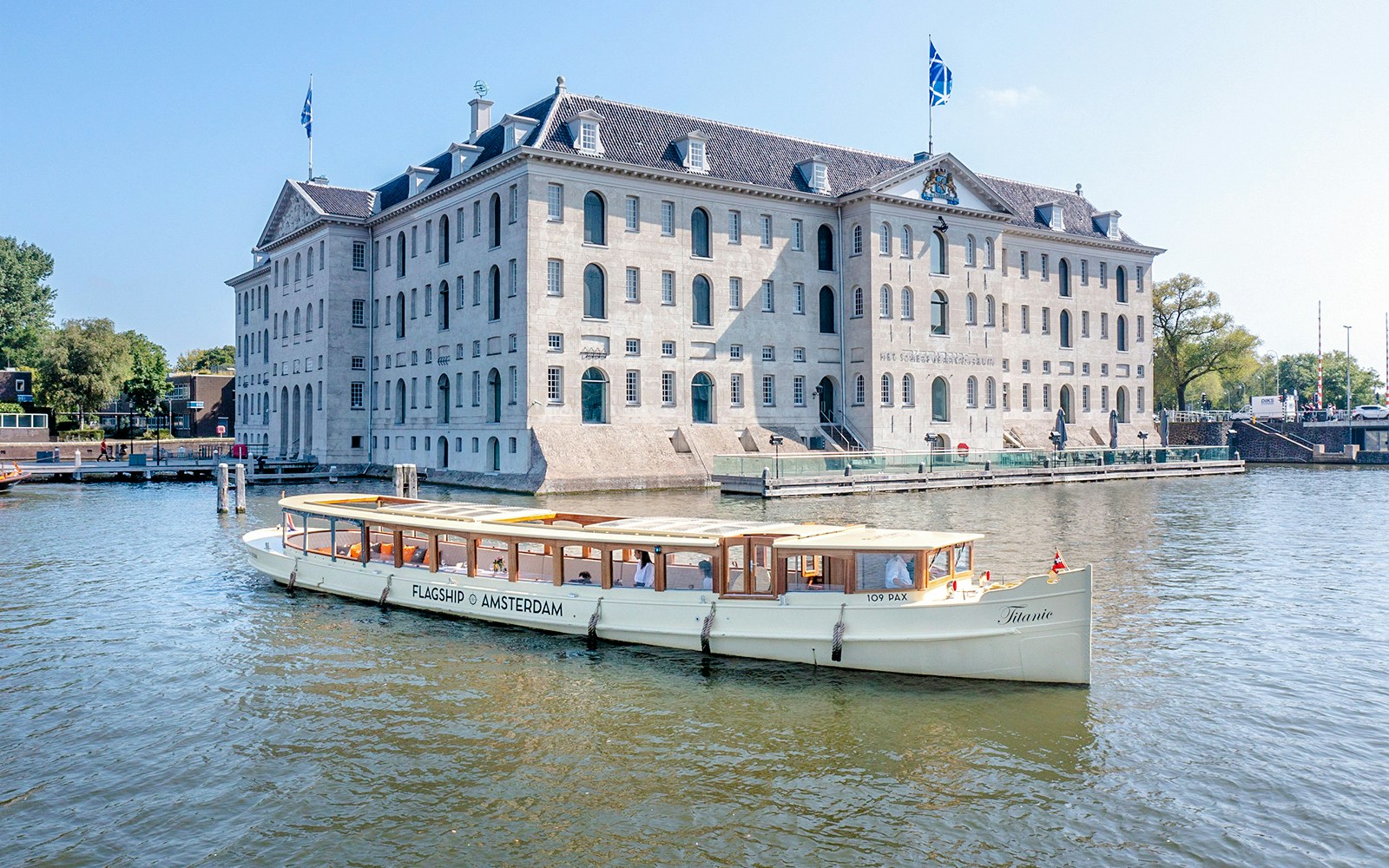 Amsterdam canal cruise boat passing the National Maritime Museum.