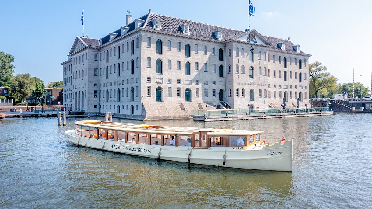 Amsterdam canal cruise boat passing the National Maritime Museum.
