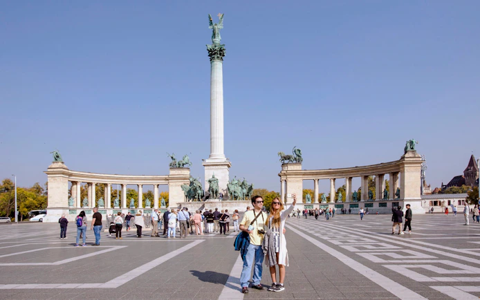 Tourists at Heroes' Square with Millennium Monument, Budapest, Hungary.