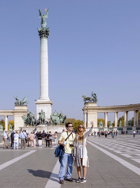Tourists at Heroes' Square with Millennium Monument, Budapest, Hungary.