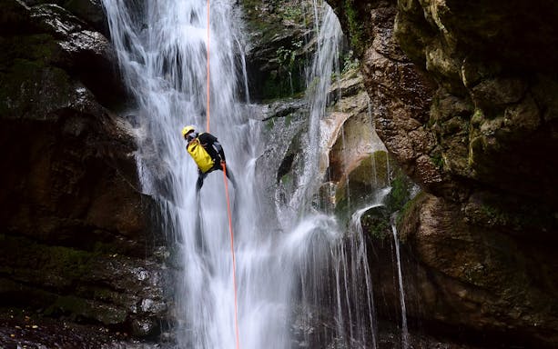 Canyoning down a waterfall at Ribeira dos Caldeirões, Azores.