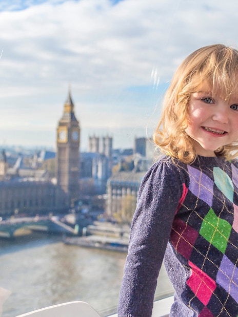 Child enjoying view of Big Ben and Houses of Parliament from London Eye capsule.