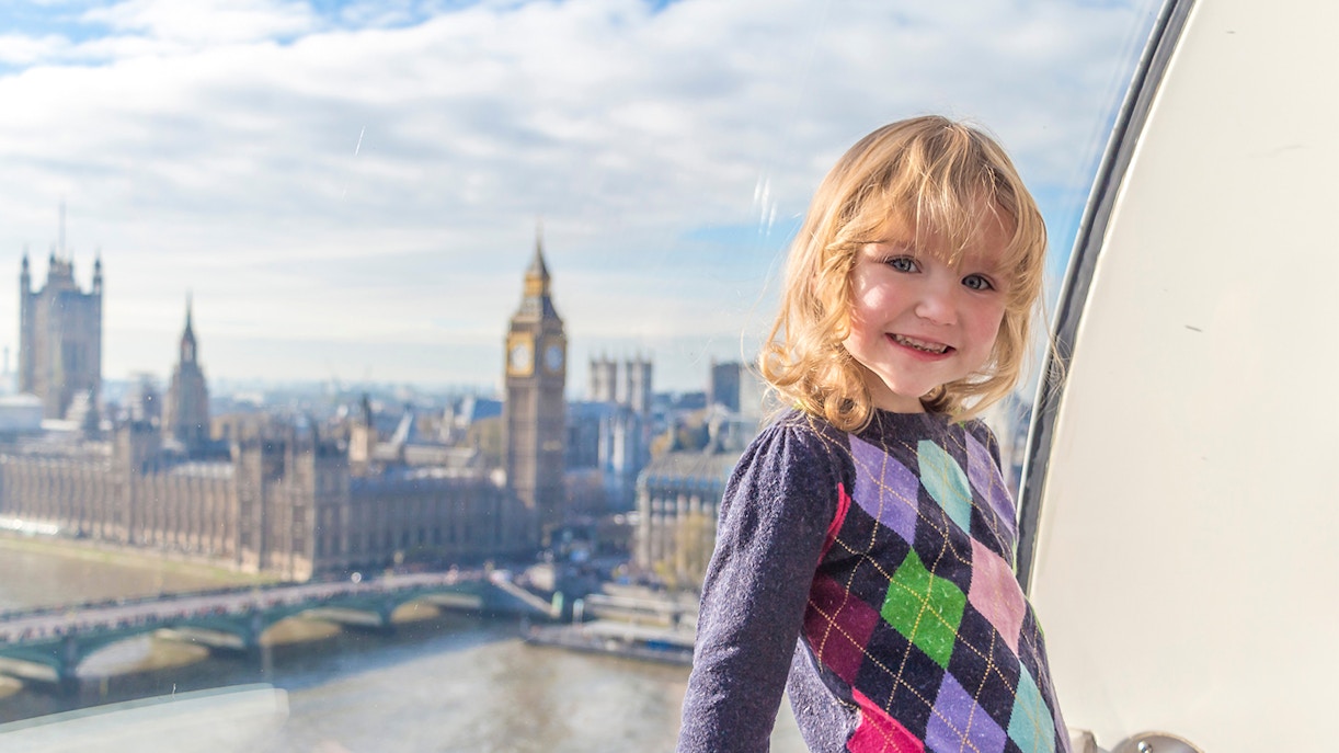 Child enjoying view of Big Ben and Houses of Parliament from London Eye capsule.
