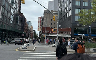 Katz's Delicatessen on a busy New York street, part of the Broadway Whodunit city exploration game.