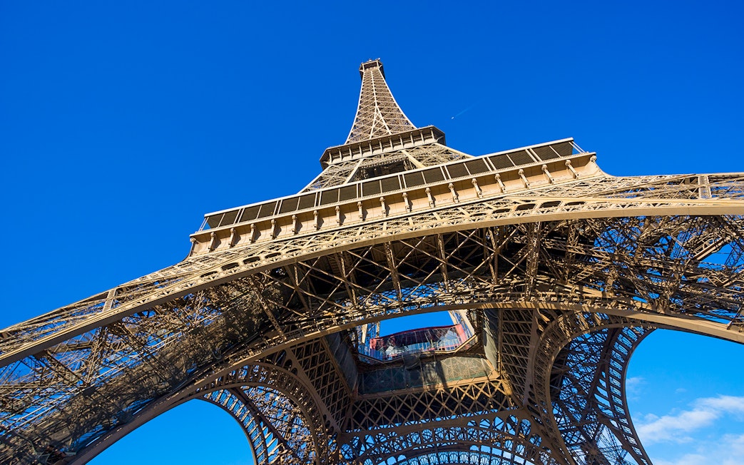 Eiffel Tower viewed from below against a clear blue sky, Paris.