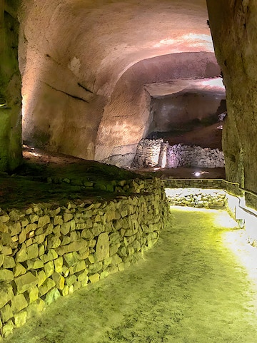 Underground stone passageway at Lapis Museum, illuminated with soft lighting.