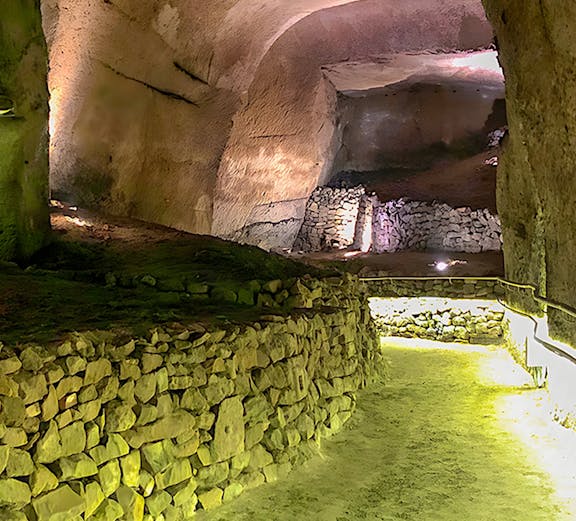 Underground stone passageway at Lapis Museum, illuminated with soft lighting.
