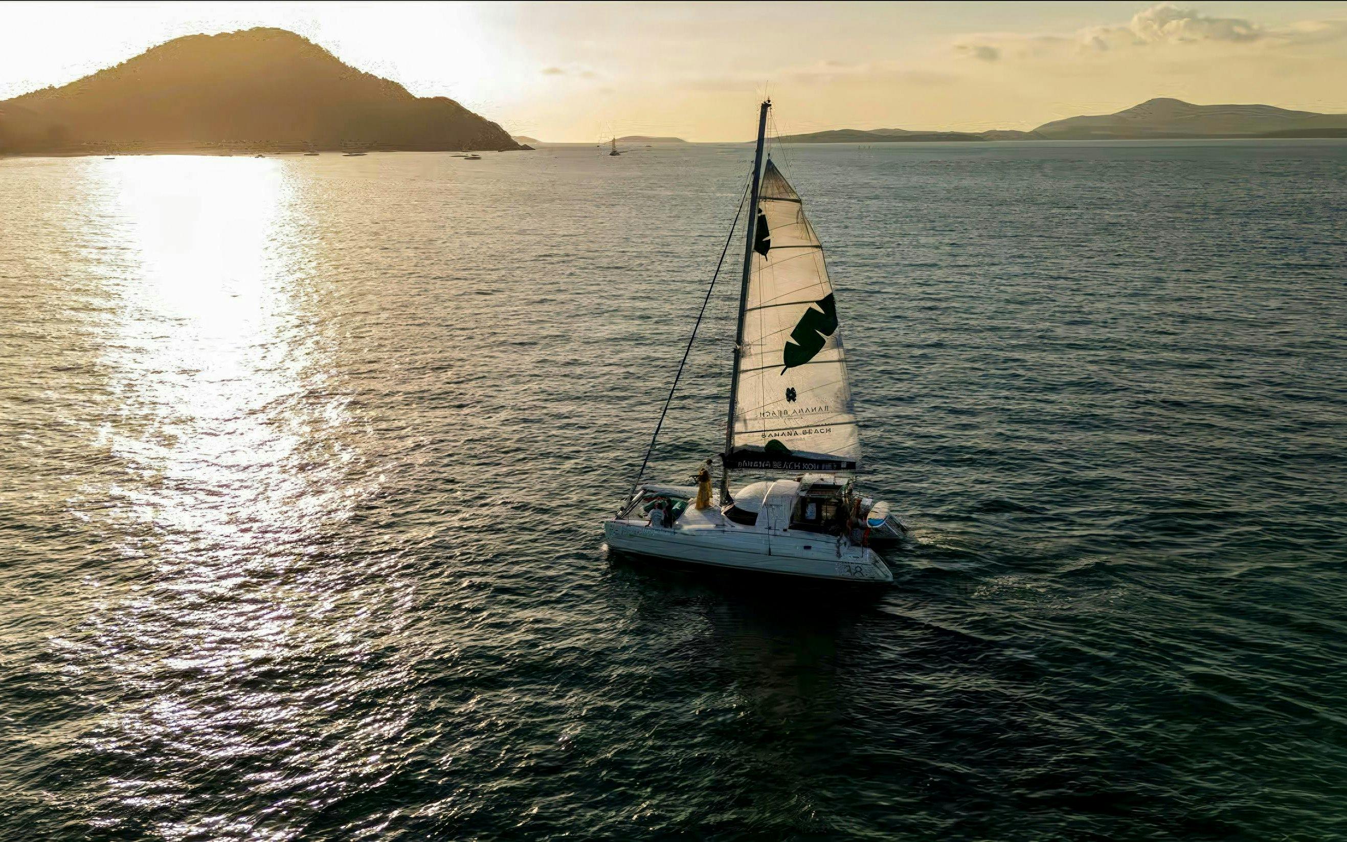 Sailboat cruising at sunset near Banana Beach, Koh Hey.