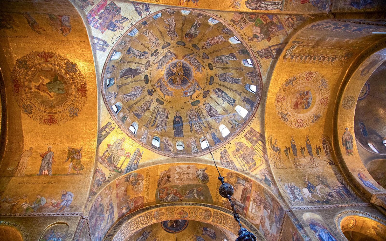 St. Mark's Basilica facade with intricate arches and mosaics, Venice, Italy.