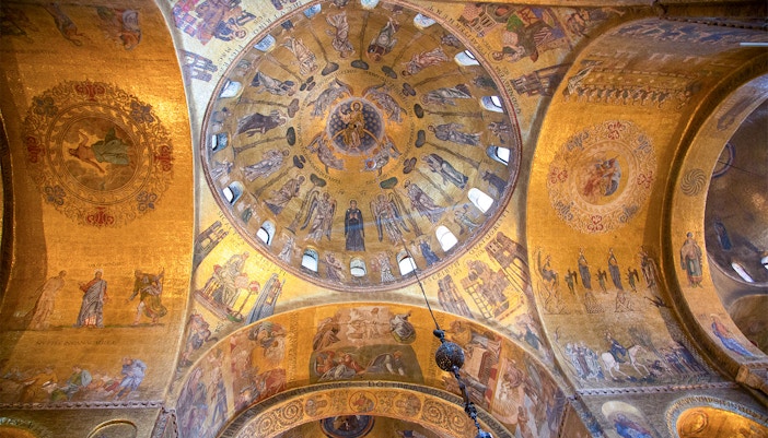 St. Mark's Basilica facade with intricate arches and mosaics, Venice, Italy.