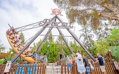 Pirate ship ride at Zoomarine Portugal with visitors enjoying the swing.