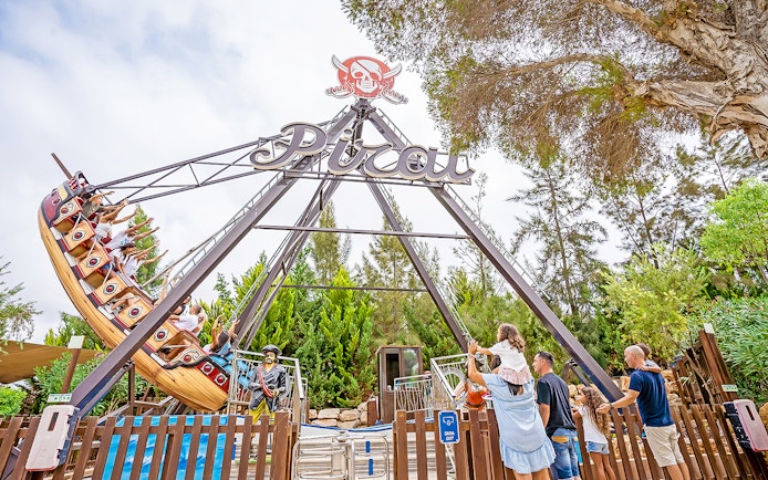 Pirate ship ride at Zoomarine Water Park with visitors enjoying the swing.