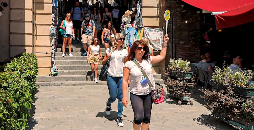 Tour guide leading group in San Gimignano during day trip from Florence.