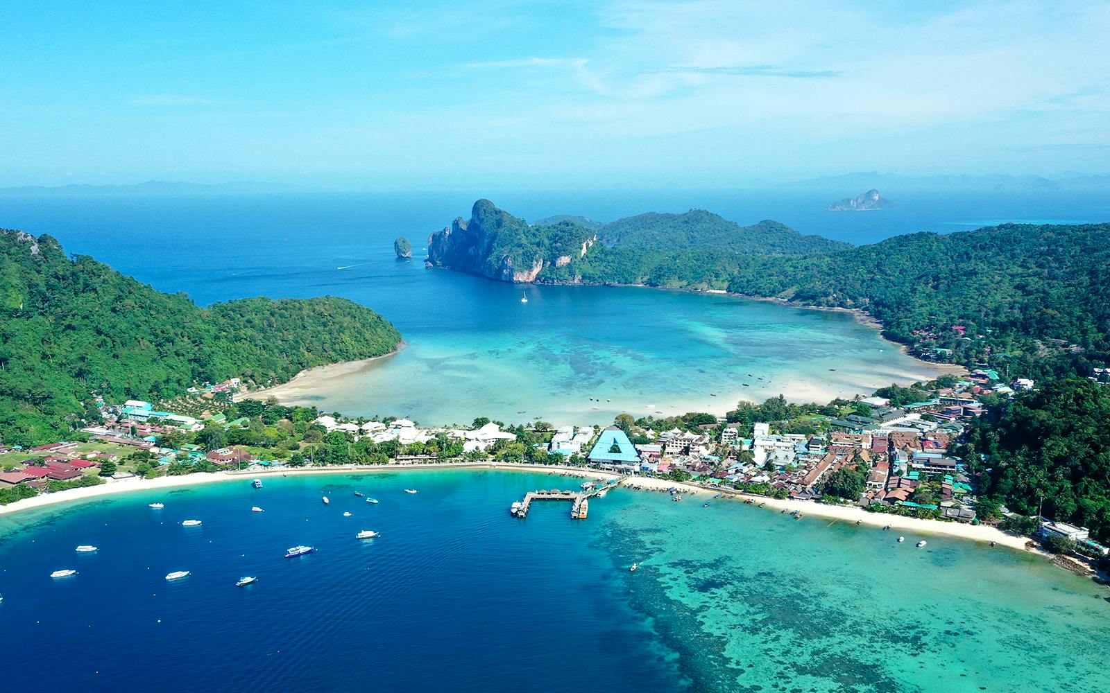 Aerial view of Tonsai Village, Phi Phi Islands, with boats in turquoise waters.